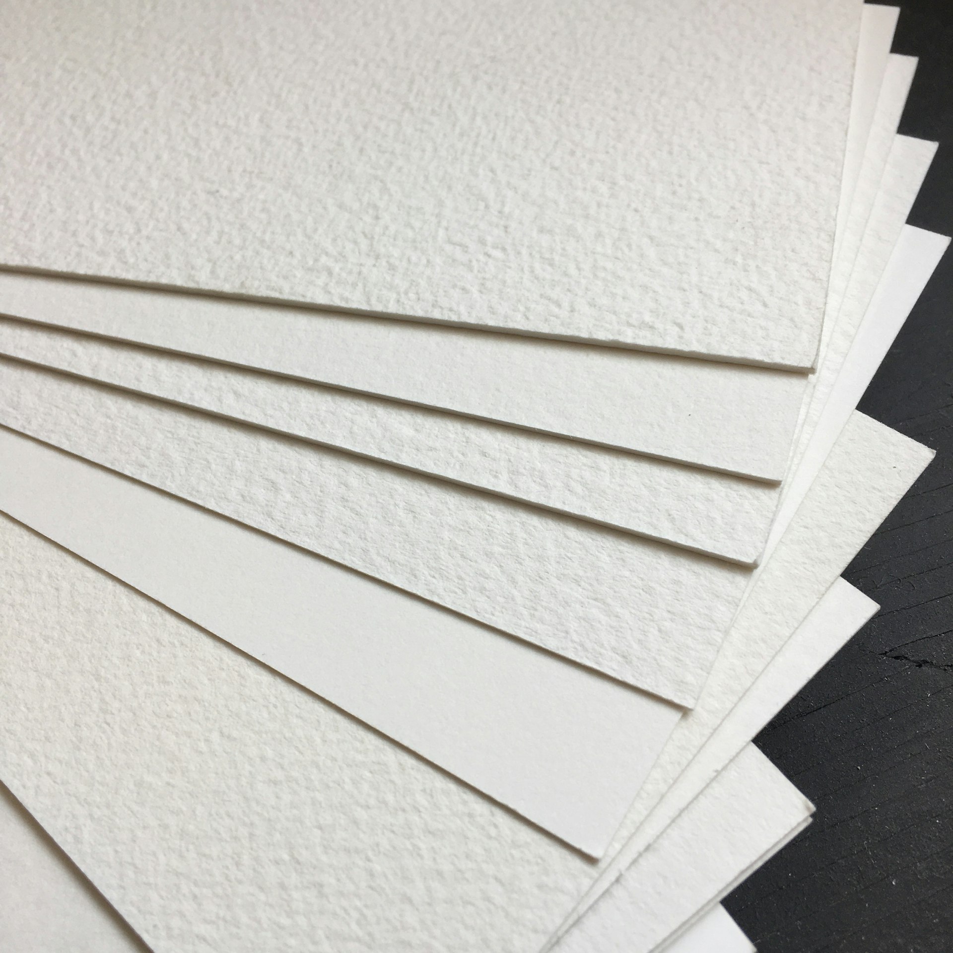 a pile of white paper sitting on top of a table